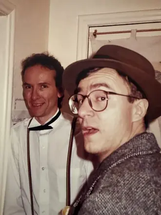 Robert and a friend in hats and round glasses, mugging for the camera, November 1990.