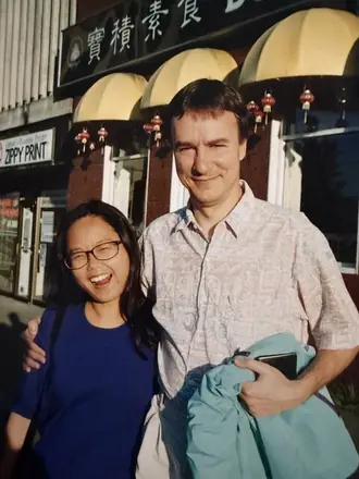 Robert and Kyong-ae laughing under Chinatown awnings.